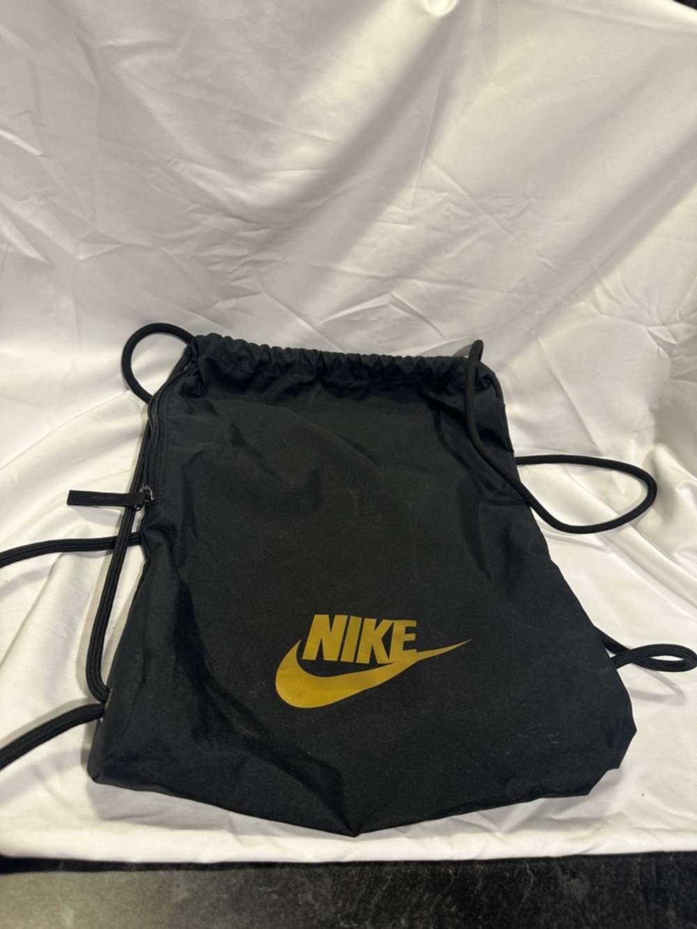 Nike Black Drawstring Backpack with Gold Swoosh